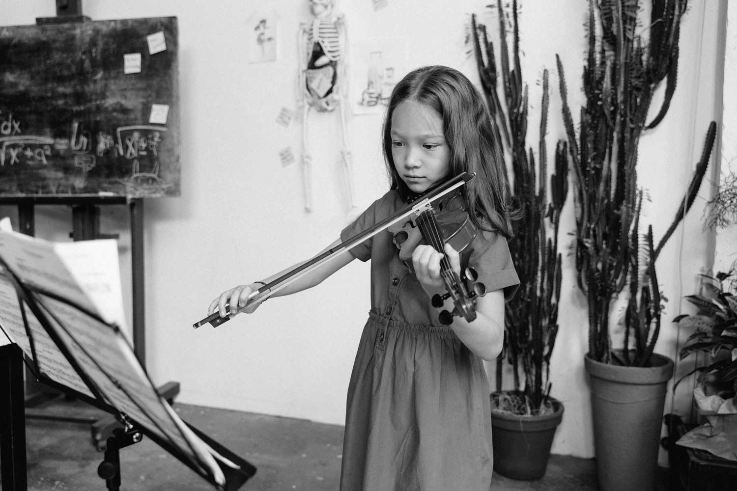 child playing violin - Muhlenberg Music Mission