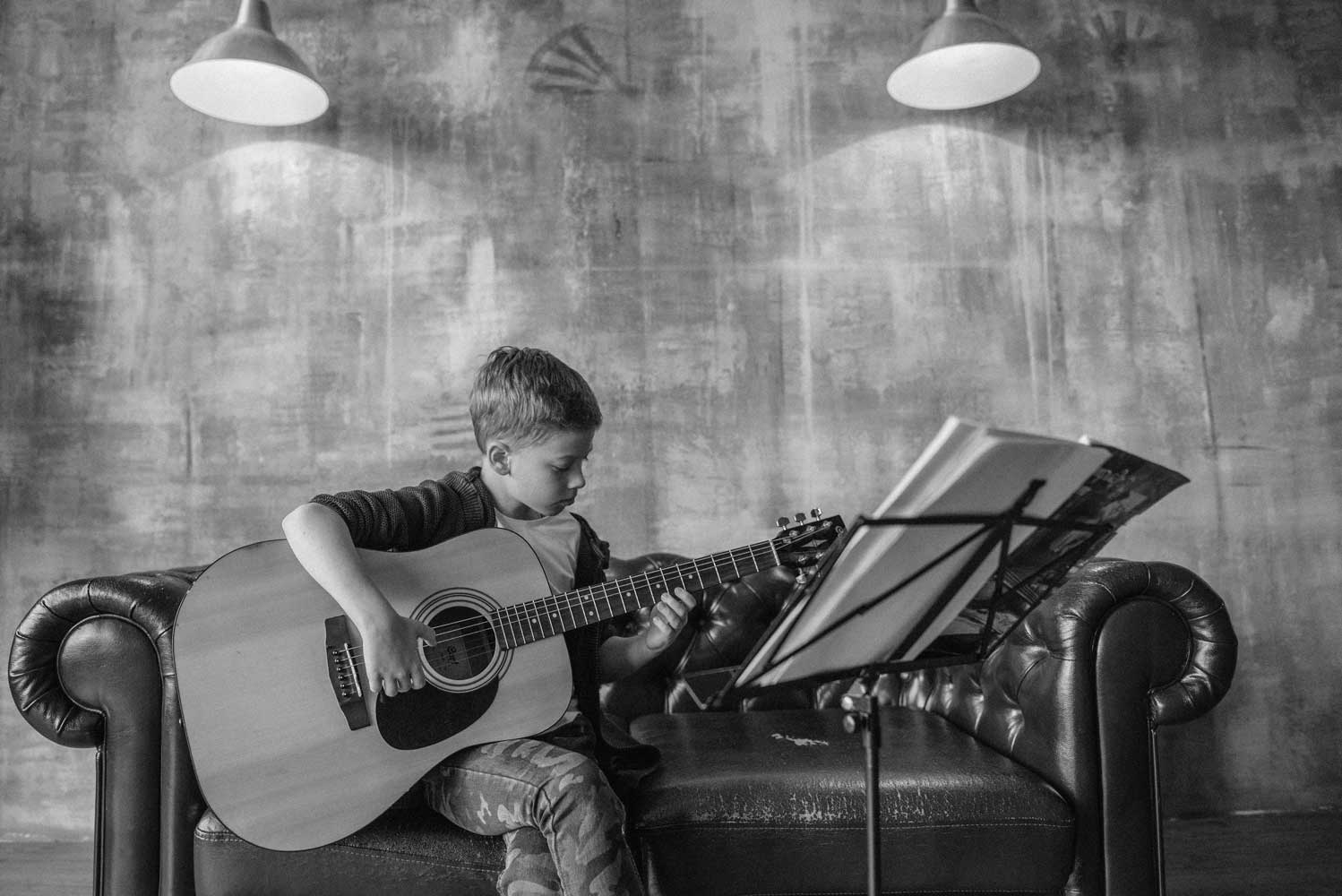 child playing guitar - Muhlenberg Music Mission